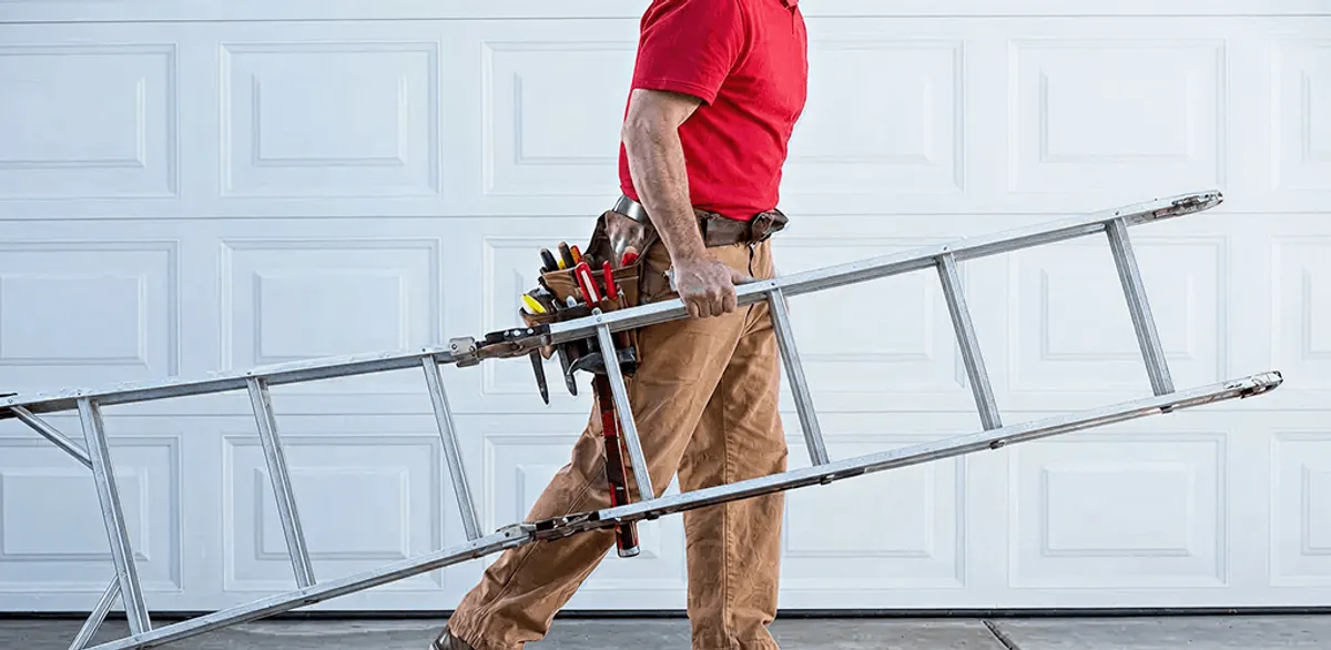 Garage door repair technician arriving with tools and ladder in San Francisco, CA