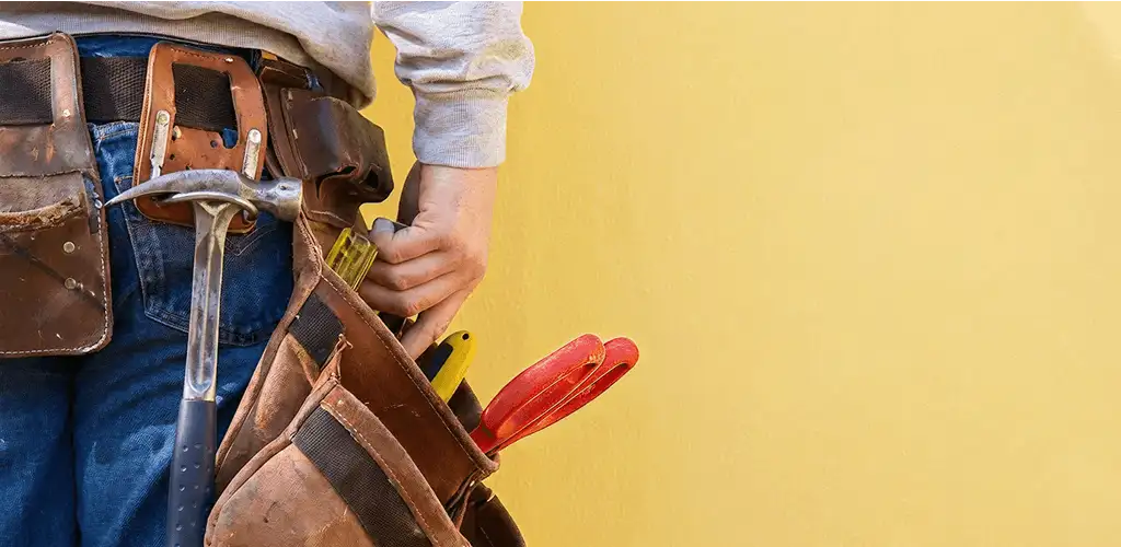 Handyman with tool belt ready for home repairs and maintenance in San Francisco, CA