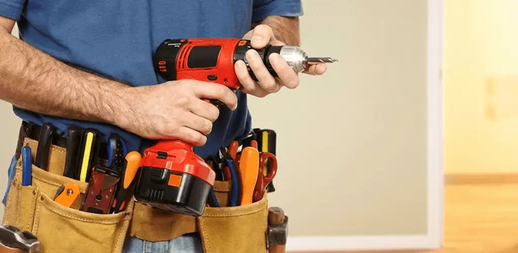 Handyman holding a power drill for home repairs and installations in San Francisco, CA
