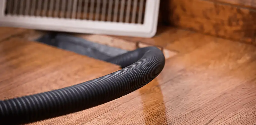 Air duct cleaning hose inserted into a floor vent for ductwork cleaning in San Francisco, CA