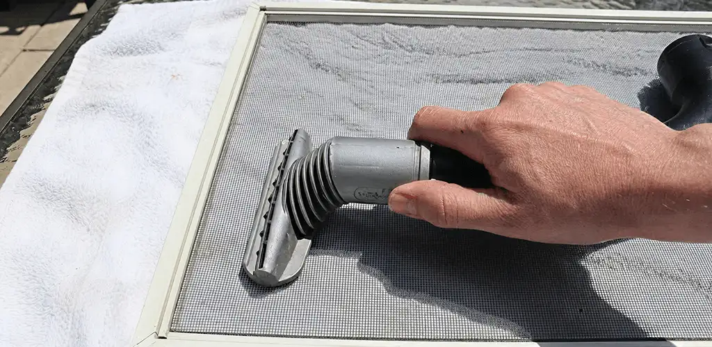 Window screen repair cleaning and fixing a damaged screen mesh in San Francisco, CA