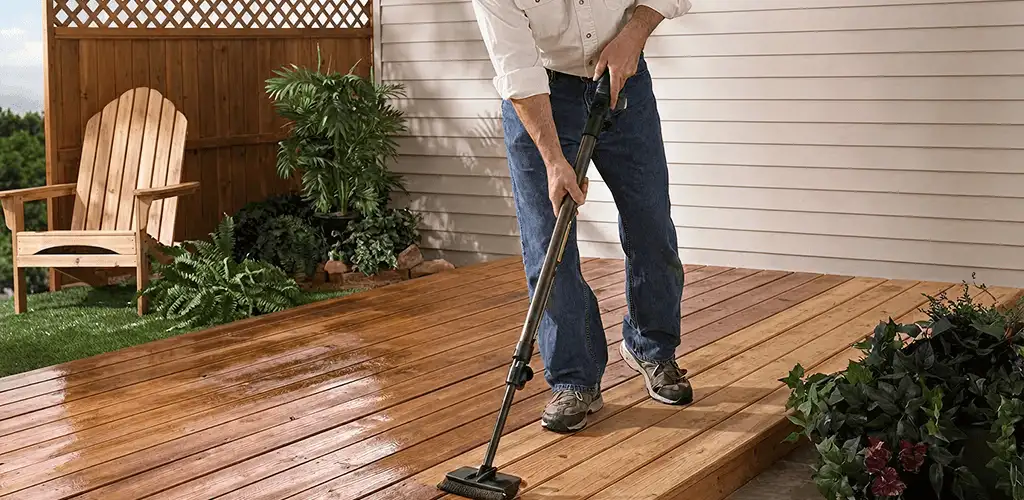 Deck staining service applying stain to a backyard wood deck in San Francisco, CA